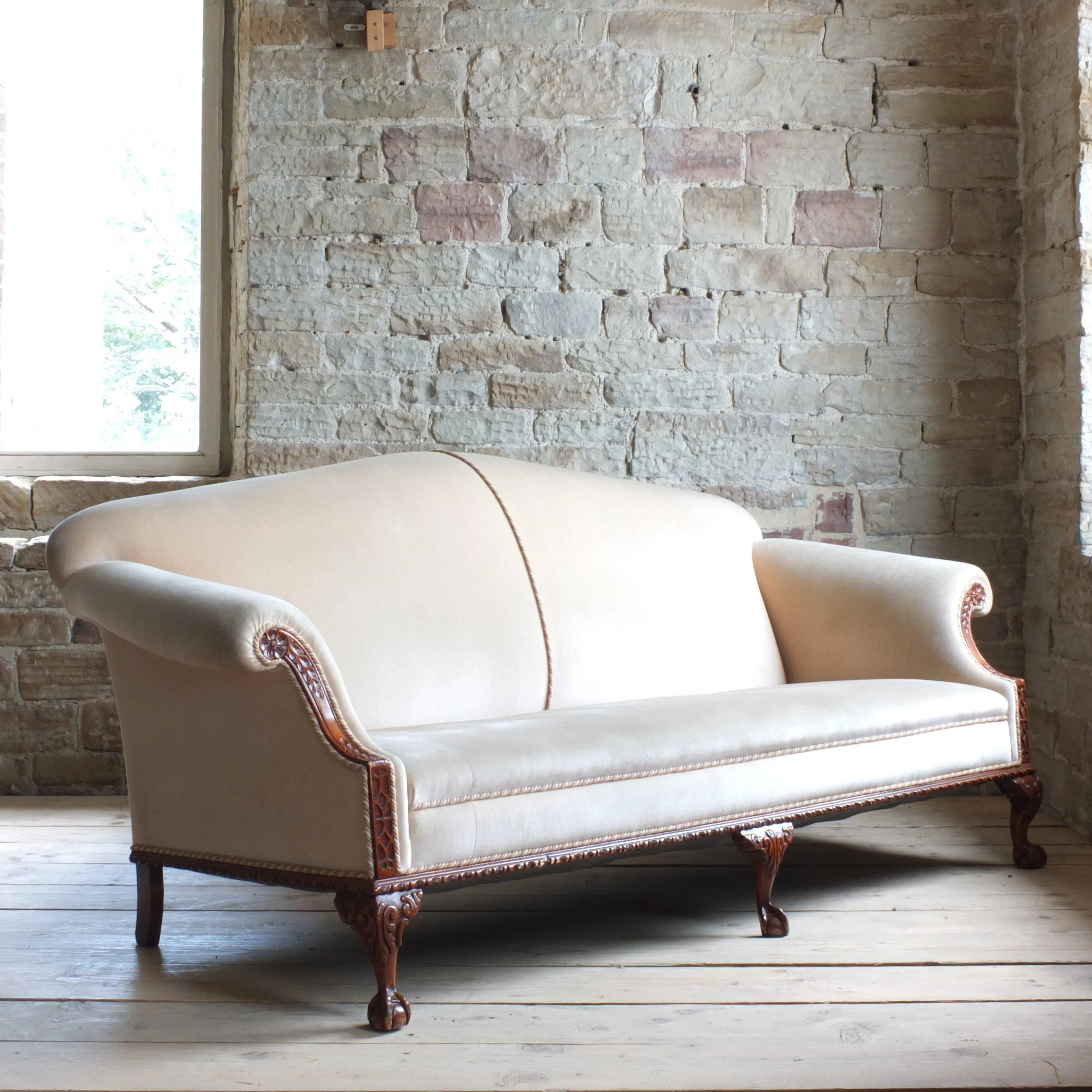 Antique early 20th century camel back sofa